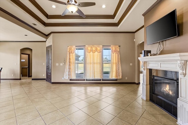 unfurnished living room featuring a tray ceiling, ceiling fan, crown molding, and light tile patterned flooring