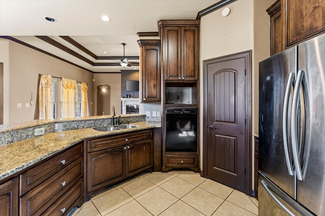 kitchen with stainless steel fridge, ceiling fan, crown molding, sink, and black oven