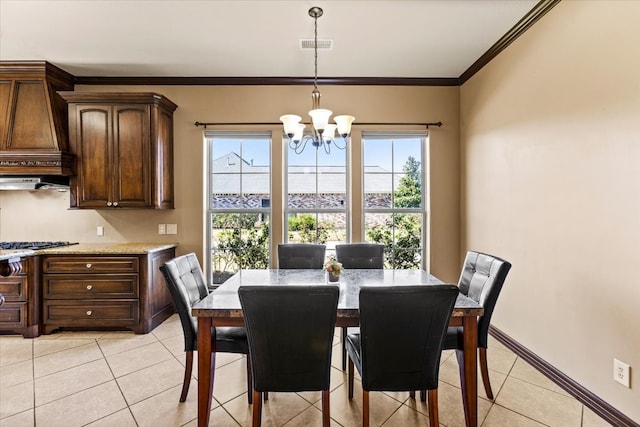 dining space with a notable chandelier, light tile patterned floors, and ornamental molding