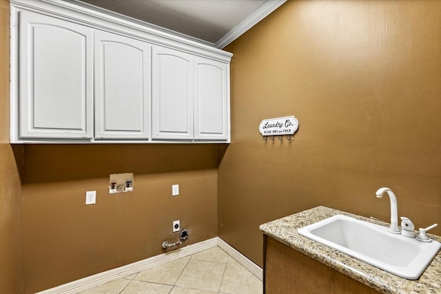 laundry room with sink, cabinets, hookup for an electric dryer, crown molding, and hookup for a washing machine