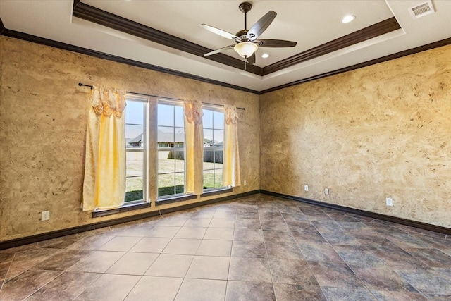 unfurnished room with a tray ceiling, ceiling fan, and ornamental molding