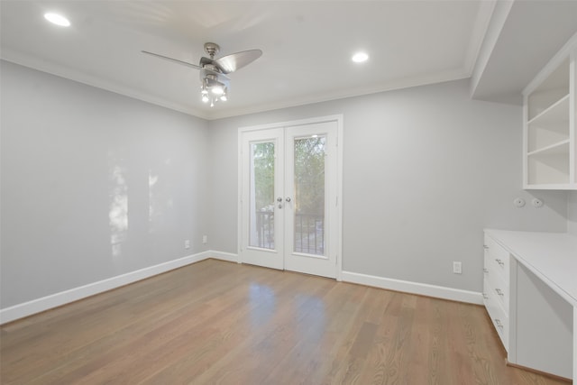 empty room with ceiling fan, light hardwood / wood-style floors, ornamental molding, and french doors