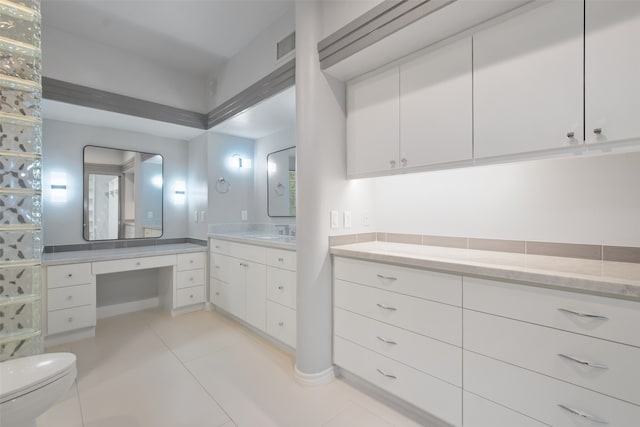 bathroom with tile patterned flooring, vanity, and toilet