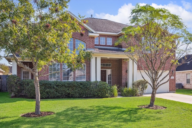 view of front facade with central AC, a front yard, and a garage