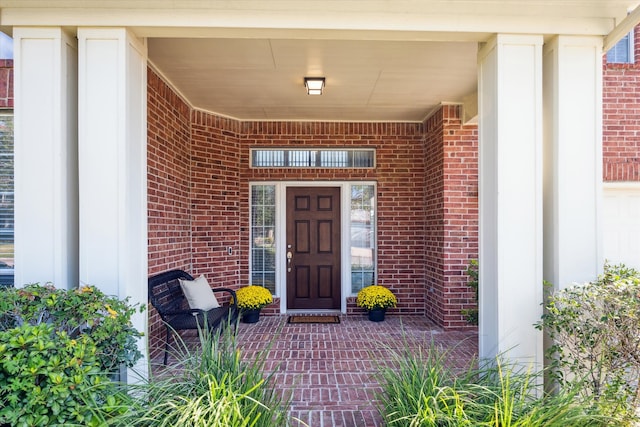 view of exterior entry featuring covered porch