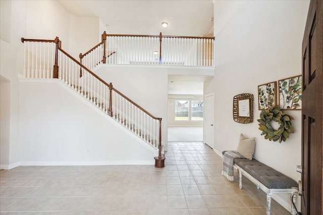 foyer with light tile patterned floors and a high ceiling