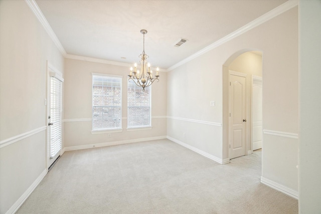 spare room featuring a chandelier, crown molding, and light colored carpet