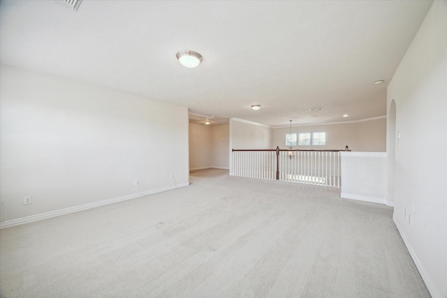 unfurnished room with light colored carpet and crown molding