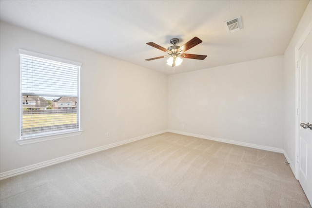 carpeted spare room with ceiling fan