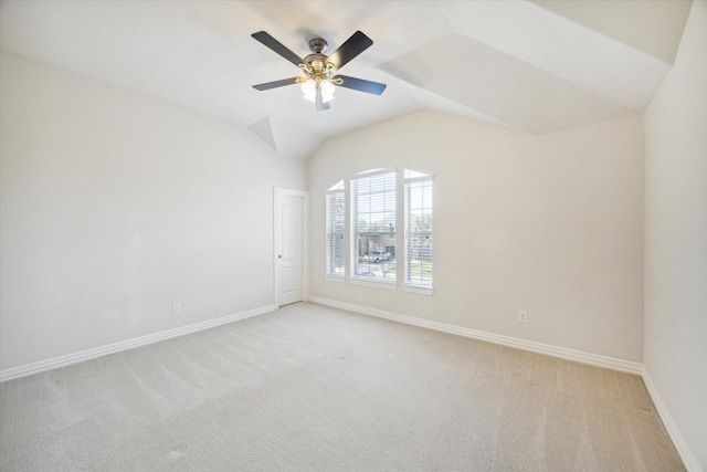 unfurnished room with ceiling fan, lofted ceiling, and light carpet