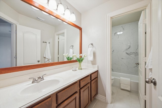 full bathroom with tile patterned flooring, vanity, toilet, and tiled shower / bath combo