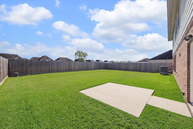 view of yard with central AC unit and a patio area