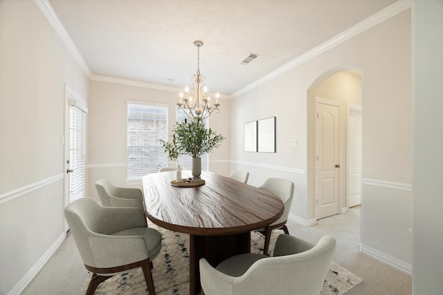 dining room with light carpet, crown molding, and a notable chandelier