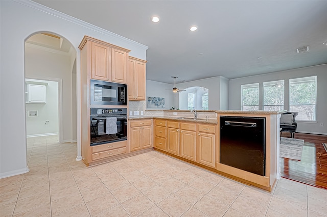 kitchen with kitchen peninsula, light brown cabinetry, crown molding, and black appliances