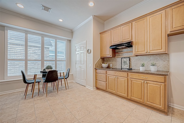 kitchen featuring stone counters, light tile patterned floors, plenty of natural light, and ornamental molding