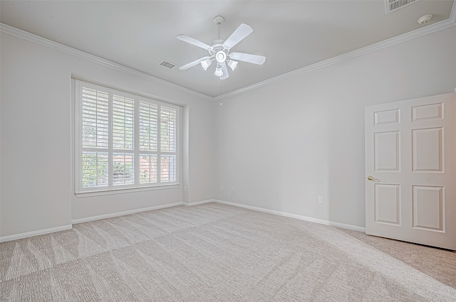 empty room featuring ceiling fan, light colored carpet, and ornamental molding