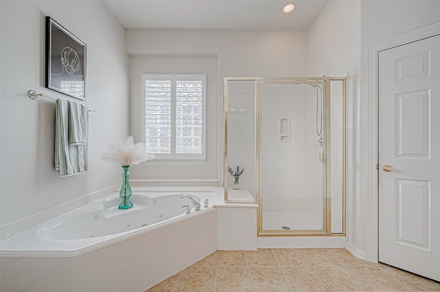 bathroom featuring tile patterned floors and shower with separate bathtub