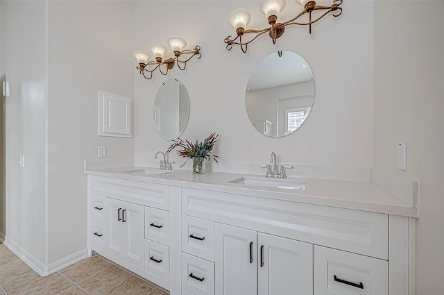 bathroom with vanity, tile patterned floors, and a notable chandelier