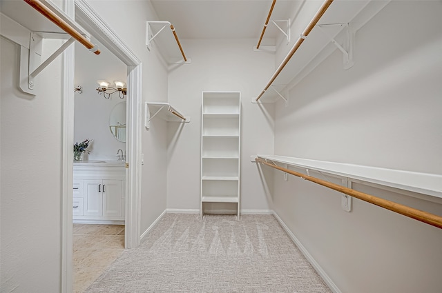 spacious closet with light tile patterned flooring and sink