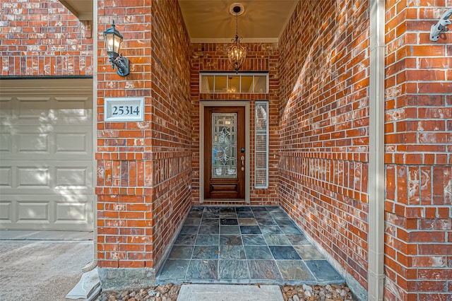 doorway to property with a garage