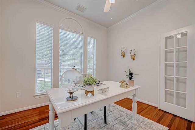 office space featuring ceiling fan, a healthy amount of sunlight, wood-type flooring, and crown molding