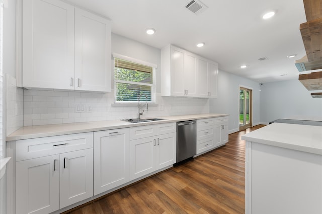 kitchen featuring dishwasher, sink, tasteful backsplash, dark hardwood / wood-style flooring, and white cabinets