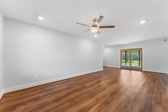 unfurnished room with ceiling fan and hardwood / wood-style flooring