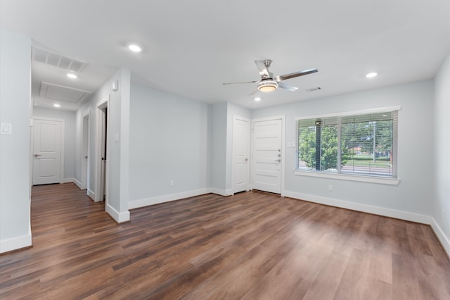 unfurnished room with ceiling fan and dark wood-type flooring