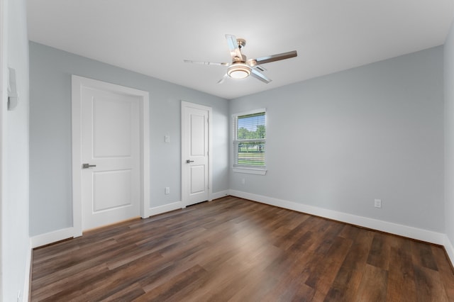 unfurnished bedroom featuring dark hardwood / wood-style floors and ceiling fan