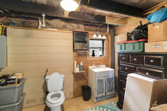 bathroom with concrete flooring, vanity, and toilet