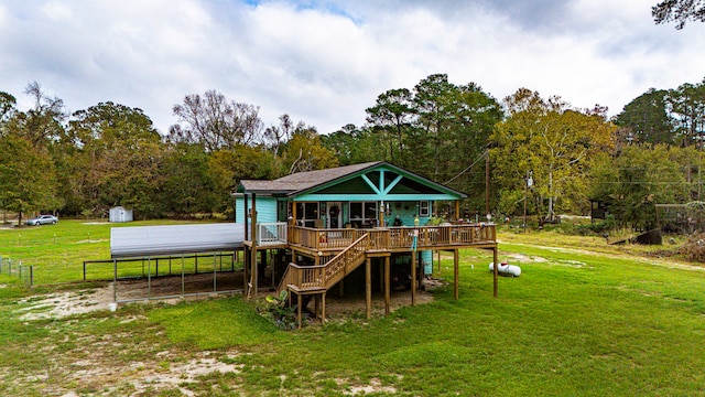 back of house with a lawn, a deck, and a storage unit