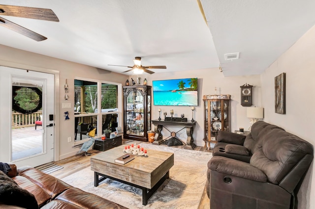 living room with light wood-type flooring and ceiling fan