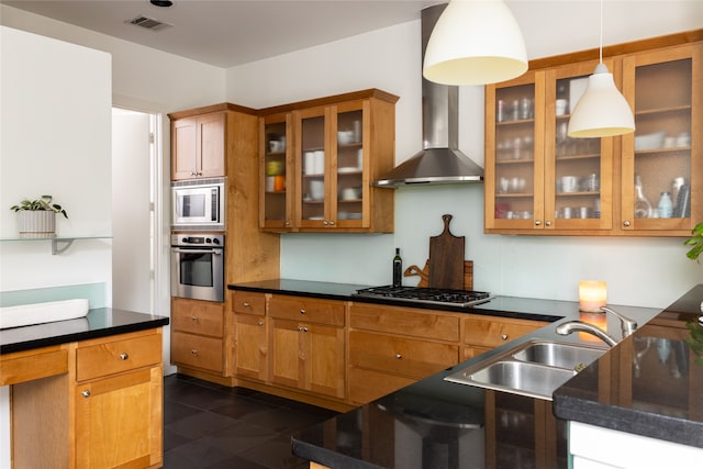 kitchen with wall chimney exhaust hood, stainless steel appliances, dark tile patterned floors, sink, and pendant lighting