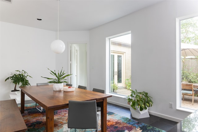 dining area with dark tile patterned floors