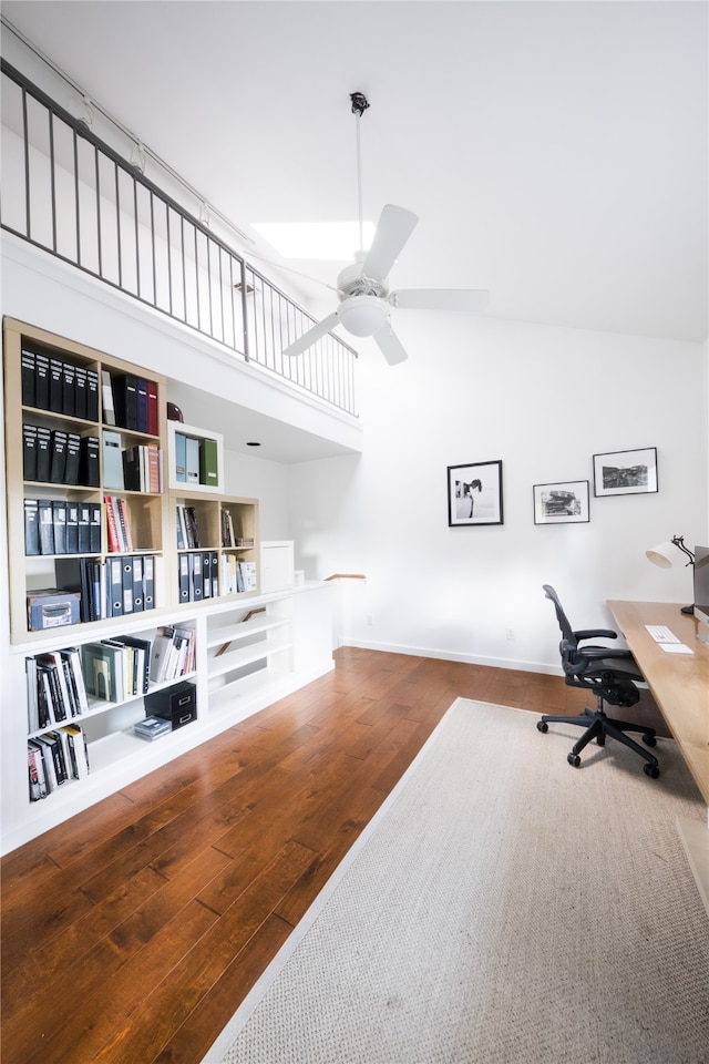 home office featuring ceiling fan, high vaulted ceiling, and wood-type flooring