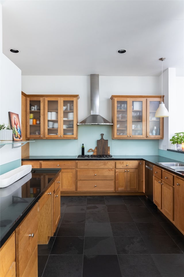 kitchen with wall chimney exhaust hood, gas stovetop, pendant lighting, dark tile patterned flooring, and dishwasher