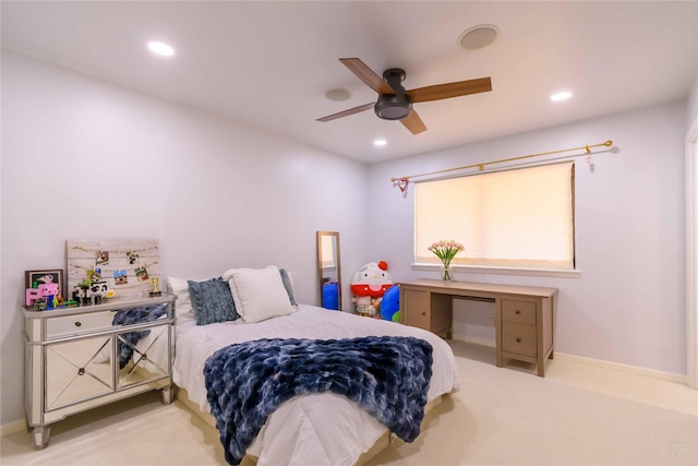 bedroom with ceiling fan and light colored carpet