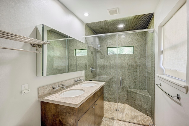 bathroom featuring vanity and an enclosed shower