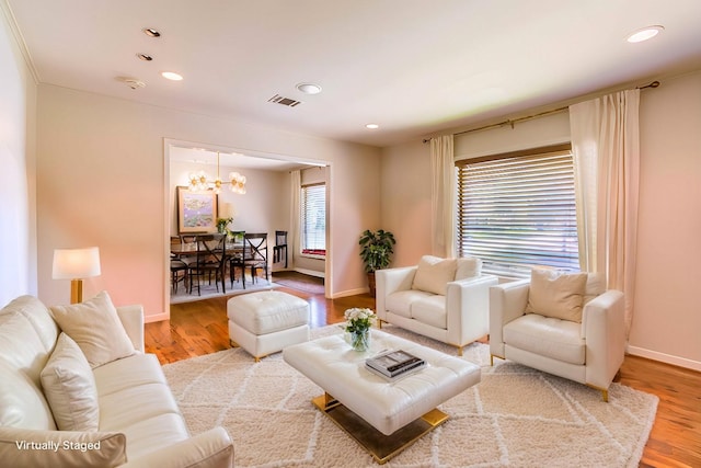 living room featuring hardwood / wood-style floors and a chandelier