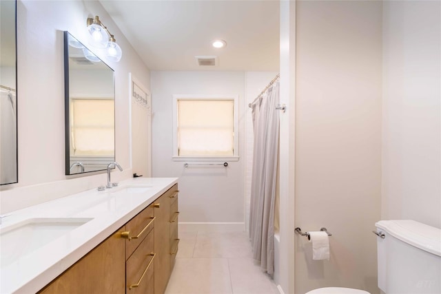 bathroom featuring tile patterned floors, vanity, and toilet