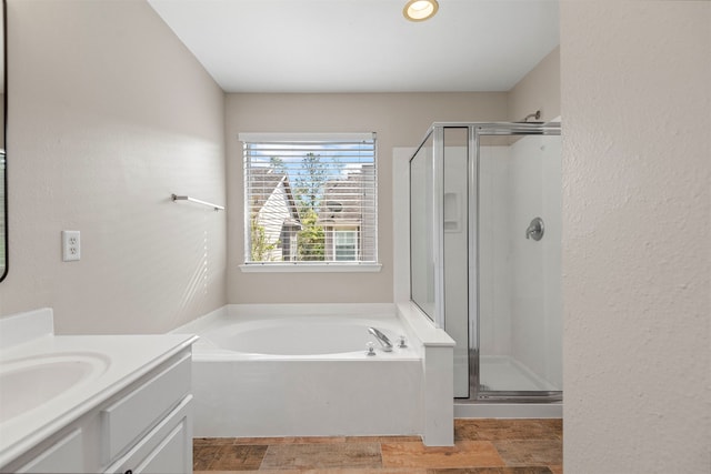 bathroom featuring vanity and shower with separate bathtub