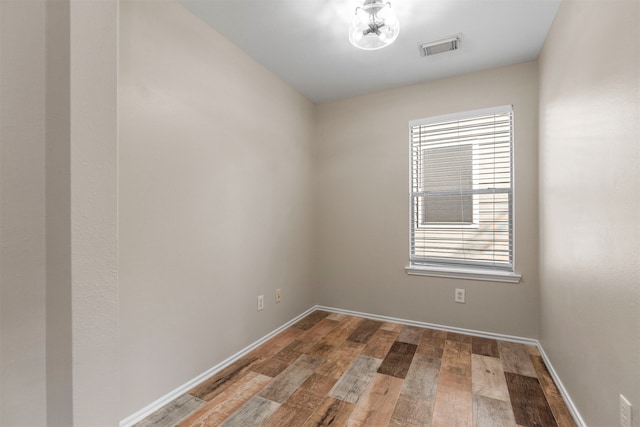 empty room with hardwood / wood-style floors