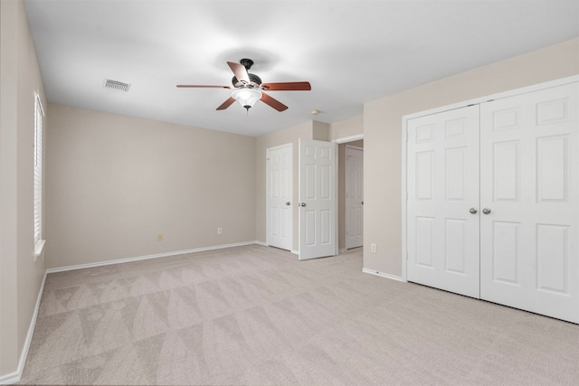 unfurnished bedroom featuring ceiling fan and light colored carpet