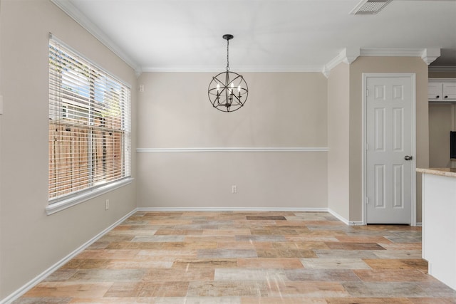 spare room featuring a chandelier, ornamental molding, a healthy amount of sunlight, and light wood-type flooring