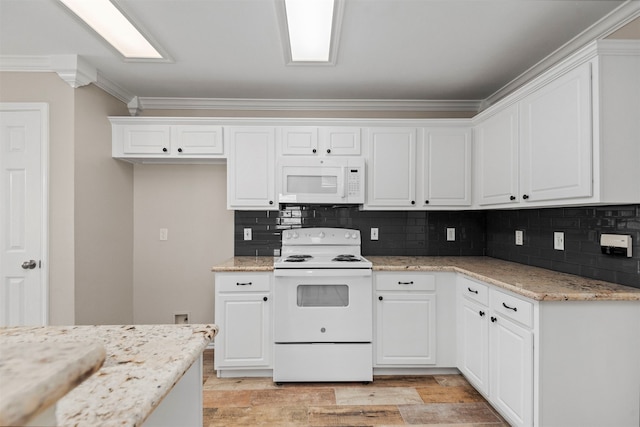 kitchen with light stone countertops, backsplash, ornamental molding, white appliances, and white cabinets