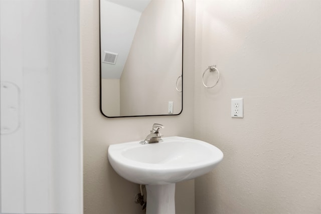 bathroom featuring vaulted ceiling