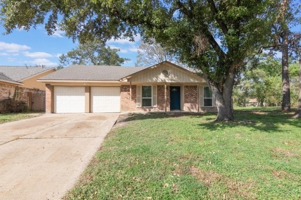 ranch-style home with a front yard and a garage