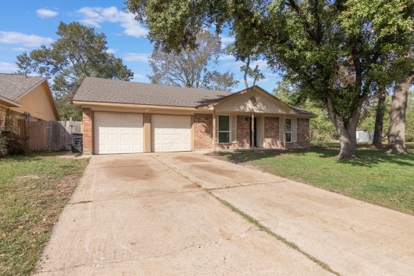 ranch-style house featuring a garage and a front lawn