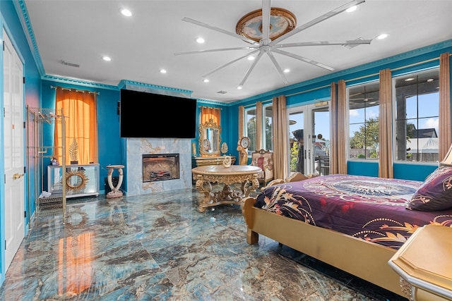 bedroom with a fireplace and ceiling fan