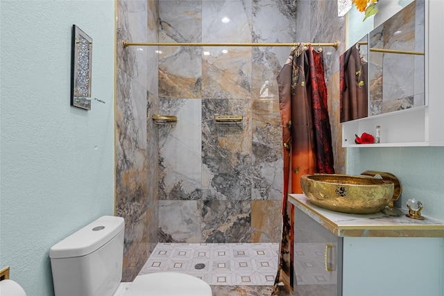 bathroom featuring walk in shower, vanity, and toilet